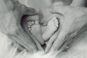 parents holding baby's feet